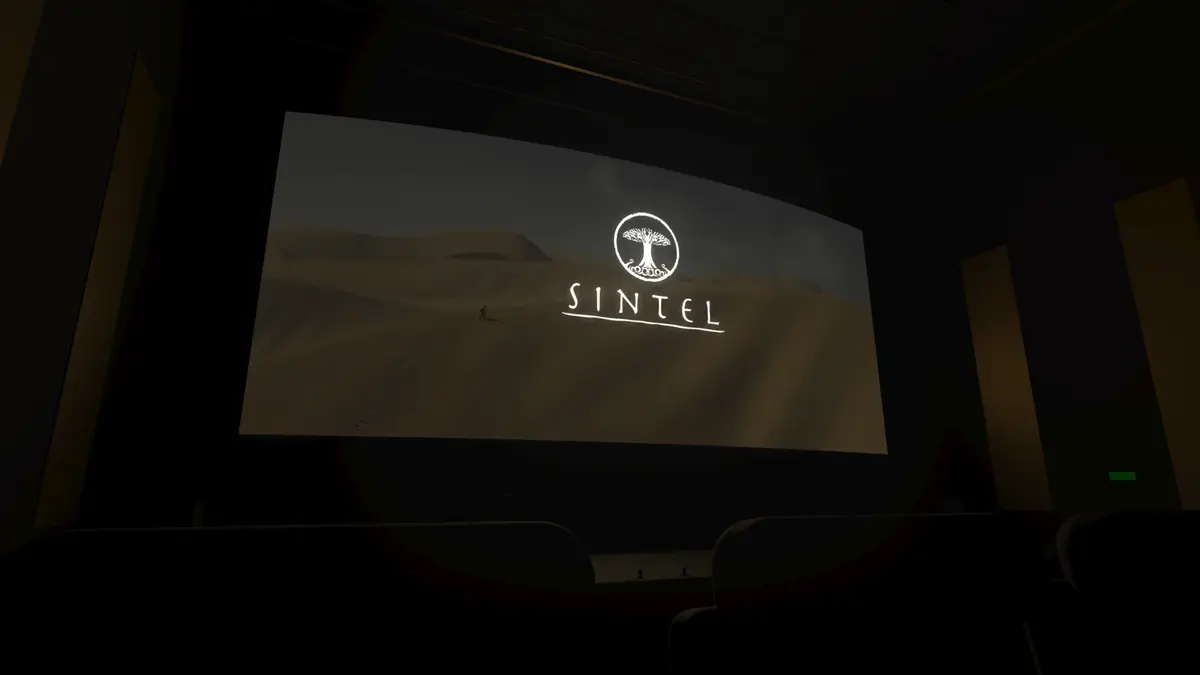 The view from a side seat in the 3D theatre, looking across the rows at the curved screen.